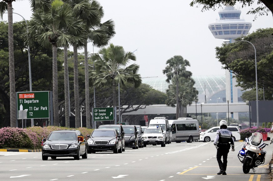 epa06798054 The car with flags flying and accompanying motorcade carrying North Korean leader Kim Jong-un, heads into the city out of the airport after he touched down in Singapore, 10 June 2018. The  ...