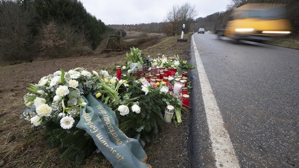 Flowers and candles stand in Ulmet, near Kusel, Germany, Friday, Feb. 4, 2022 at the scene where two police officers were shot during a traffic stop . German investigators have found nearly 400 cases  ...