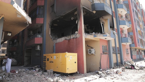 Residential buildings damaged in fighting are seen in Khartoum, Sudan, Thursday, April 20, 2023. The latest attempt at a cease-fire between the rival Sudanese forces faltered as gunfire rattled the ca ...