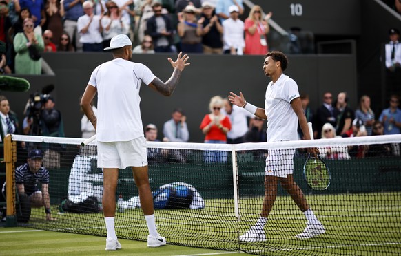 epa10038688 Nick Kyrgios (L) of Australia is congratulated at the net by his opponent Paul Jubb of Great Britain after winning their men&#039;s first round match at the Wimbledon Championships, in Wim ...