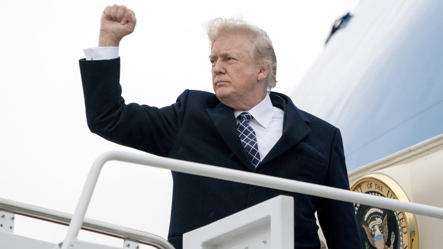 President Donald Trump gestures as he boards Air Force One at Andrews Air Force Base, Md., Friday, Jan. 12, 2018, to travel to Palm Beach International Airport in West Palm Beach, Fla. (AP Photo/Andre ...