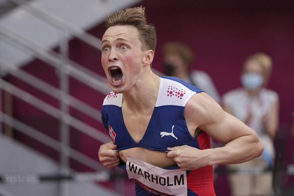 Karsten Warholm, of Norway, celebrates after winning the gold medal in the men&#039;s 400-meter hurdles at the 2020 Summer Olympics, Tuesday, Aug. 3, 2021, in Tokyo.(AP Photo/David J. Phillip)