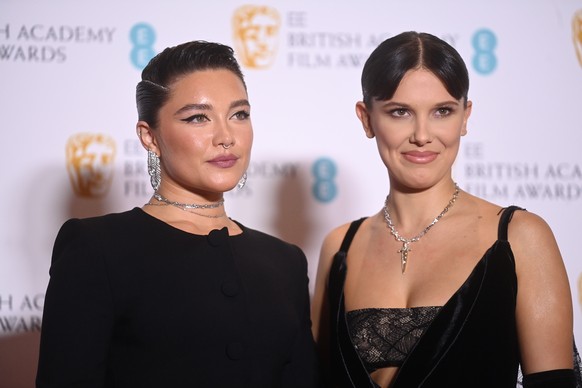 epa09822517 Florence Pugh (R) and Millie Bobby Brown (R) pose in the press room during the 75th BAFTA Film Awards at the Royal Albert Hall in London, Britain, 13 February 2022. The ceremony is hosted  ...