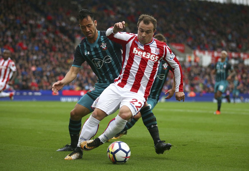 Southampton&#039;s Maya Yoshida, left, and Stoke City&#039;s Xherdan Shaqiri during the English Premier League soccer match between Stoke City and Southampton at the bet365 Stadium, Stoke, England, Sa ...