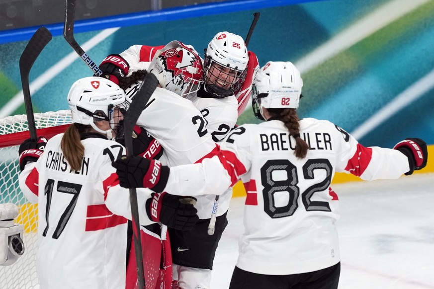 Team Switzerland players celebrate after beating Finland in a women's ice hockey quarterfinal match at the 2026 Winter Olympics, in Milan, Italy, Saturday, Feb. 14, 2026. (AP Photo/Carolyn Kaster ...