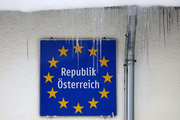 Icicles hang in front of an Austrian border sign at the Italian and Austrian border in Gries am Brenner, Austria, Sunday, Dec. 13, 2020. (AP Photo/Matthias Schrader)
