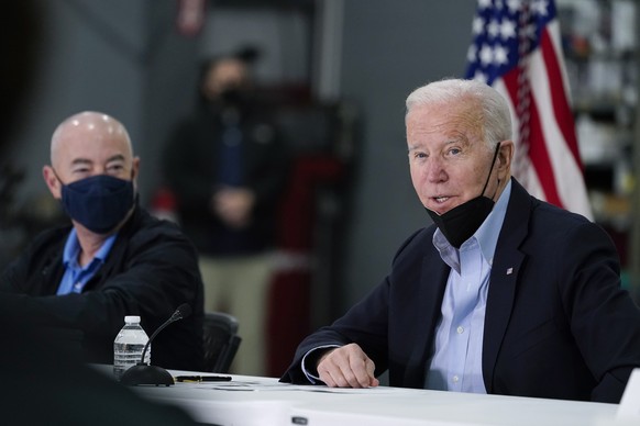 President Joe Biden speaks as he attends a briefing from local leaders on the storm damage from tornadoes and extreme weather at Mayfield Graves County Airport in Mayfield, Ky., Wednesday, Dec. 15, 2021. Homeland Security Secretary Alejandro Mayorkas listens at left. (AP Photo/Andrew Harnik)
Joe Biden