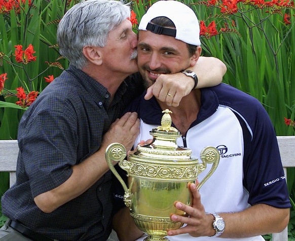 WIM68-20010709, LONDON, UNITED KINGDOM: Croatian player Goran Ivanisevic is proudly kissed by his father Srdjan after he won Men&#039;s Single Final against Australian Patrick Rafter at the All Englan ...