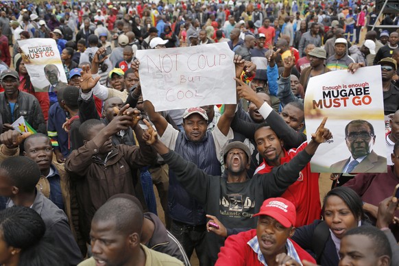 epa06336619 People taking to the streets as part of the mass action protests against President Robert Mugabe, in Harare, Zimbabwe, 18 November 2017. The Zimbabwe National Army (ZNA) has taken over the ...