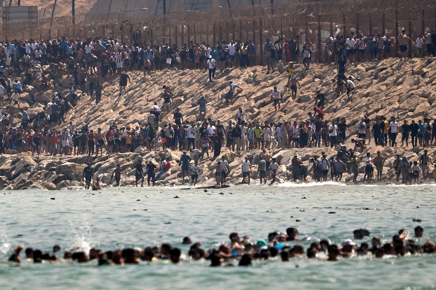 Migrants cross from Morocco into the Spanish enclave of Ceuta, Thursday, July 30, 2026. (AP Photo/Antonio Sempere)
Spain Ceuta