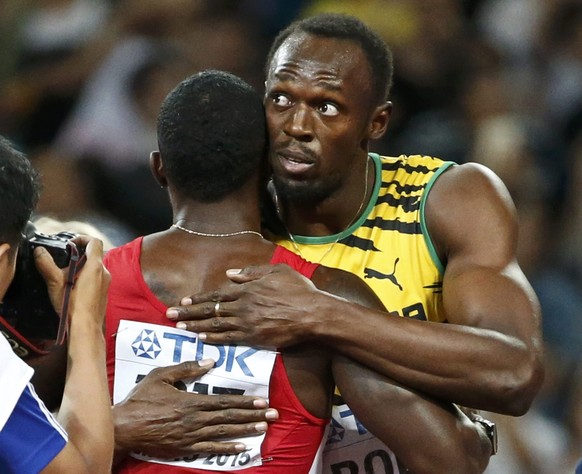 Justin Gatlin from the U.S. and and Usain Bolt of Jamaica reacts after the men&#039;s 100m final during the 15th IAAF World Championships at the National Stadium in Beijing, China August 23, 2015. REU ...