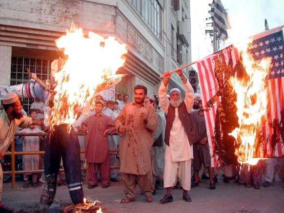 PAKISTAN PROTESTS
Pakistani religious parties alliance MMA supporters mark the third anniversary of the 11 September terrorist attacks in the United States by burning the effigy of US President George ...