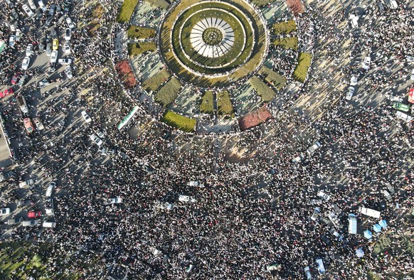 epaselect epa11774803 An aerial photo taken with a drone shows people gathering to celebrate the opposition takeover of Damascus, following the Friday prayers, at Umayyad Square in Damascus, Syria, 13 ...