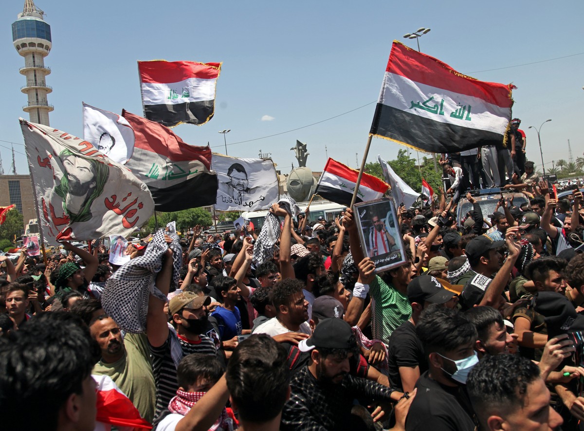 Anti-government protesters try to force their way into the Green Zone area, which houses the seat of the country's government and foreign embassies, during protests in Baghdad, Iraq, Tuesday, May ...
