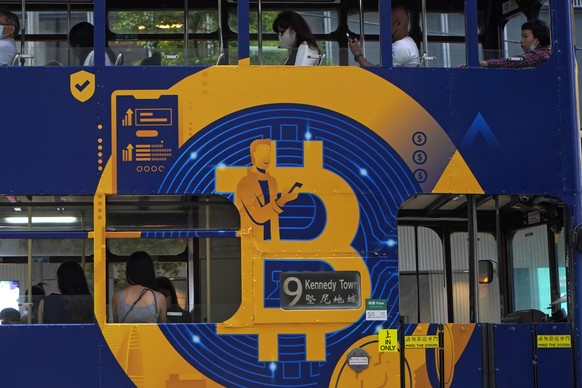 FILE - This May 12, 2021, file photo shows an advertisement for the cryptocurrency Bitcoin displayed on a tram in Hong Kong. Cryptocurrencies have surged to nearly $2.5 trillion in total value, rivali ...