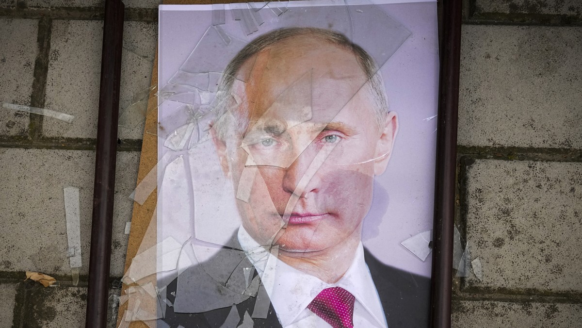 A portrait of Russian President Vladimir Putin lies on the ground near the local prison in Kherson, Ukraine, Wednesday, Nov. 16, 2022. The Russian retreat from Kherson marked a triumphant milestone in ...