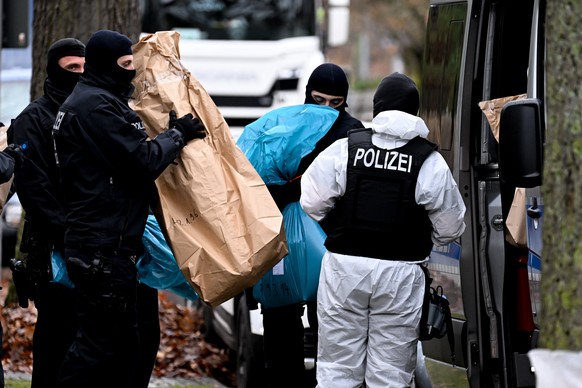 epa10353344 Police officers work during a raid in Berlin, Germany, 07 December 2022. Twenty-five people allegedly affiliated to the so-called Reichs Citizens (Reichsbuerger) movement were arrested in  ...