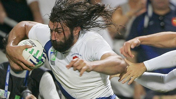 Sebastien Chabal of France, left, charges through to score a try during the Rugby World Cup Group D match between France and Namibia, Toulouse, southwestern France, Sunday Sept. 16, 2007. (AP Photo/Ka ...