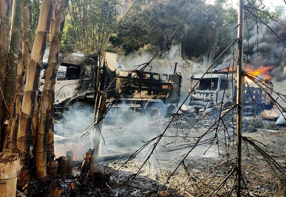 In this photo provided by the Karenni Nationalities Defense Force (KNDF), smokes and flames billow from vehicles in Hpruso township, Kayah state, Myanmar, Friday, Dec. 24, 2021. Myanmar government tro ...