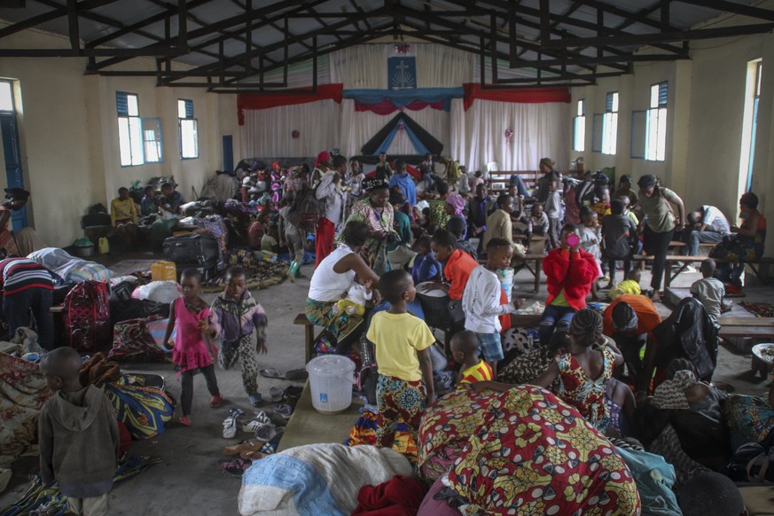 Displaced people take shelter in a church in the town of Sake, northwest of Goma, in eastern Congo Friday, May 28, 2021. Tens of thousands of people are fleeing the city of Goma in eastern Congo feari ...