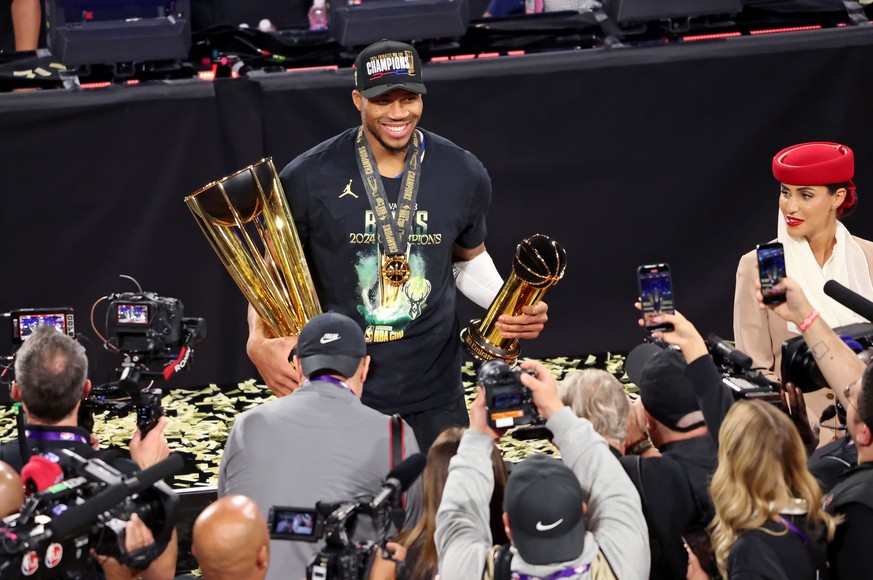 epa11783227 Milwaukee Bucks forward Giannis Antetokounmpo holds the NBA Cup and MVP trophies at the end of the NBA Cup in-season tournament final against the Oklahoma City Thunder in Las Vegas, Nevada ...
