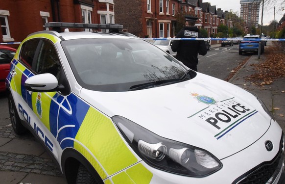 epa09583377 Police officers work inside a cordon by Rutland Avenue in Liverpool, Britain, 15 November 2021. British police announced the arrest of three men under the Terrorism Act after a car explode ...