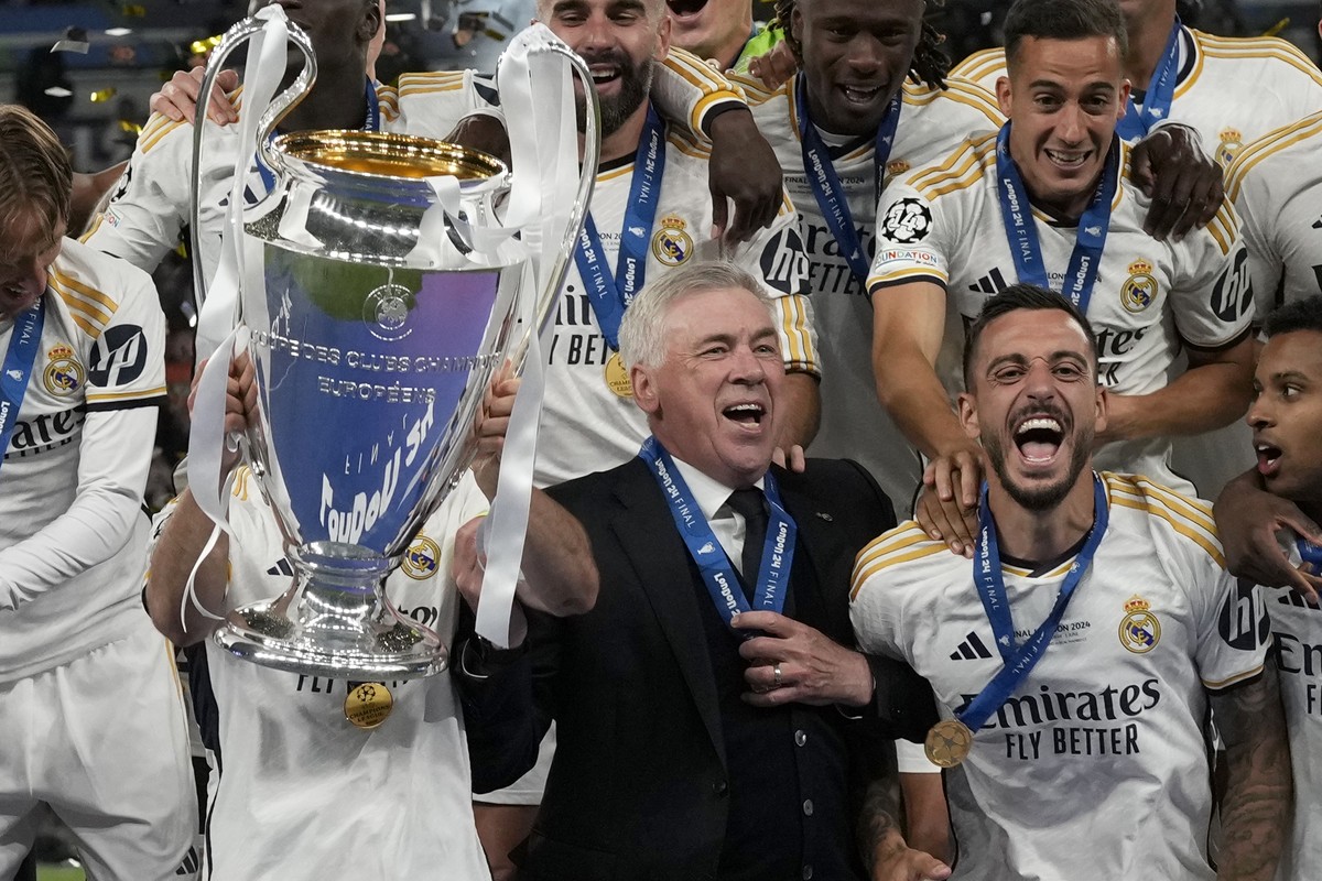 Real Madrid's head coach Carlo Ancelotti celebrates with the players after winning the Champions League final soccer match between Borussia Dortmund and Real Madrid at Wembley stadium in London,  ...