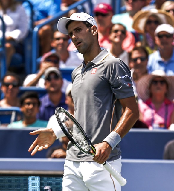 epa04895123 Novak Djokovic of Serbia looks to his coaches after giving up a point to Roger Federer of Switzerland during the final of the Western &amp; Southern Open at the Linder Family Tennis Center ...
