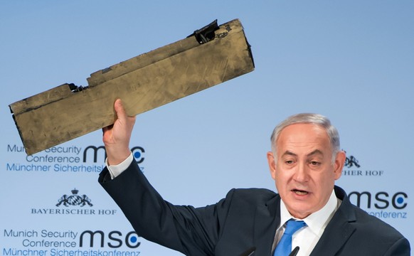 epa06538960 A handout photo made available by the Munich Security Conference (MSC) on 18 February 2018 shows the Prime Minister of the State of Israel, Benjamin Netanyahu, showing a piece of an allege ...