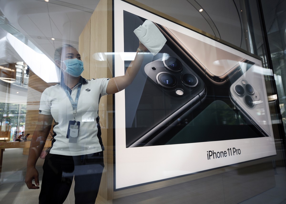 epa08575989 A Thai worker cleans a window of the new Apple Store in Bangkok, Thailand, 31 July 2020. Apple's second retail store is set to open at the Central World shopping complex, marking the  ...