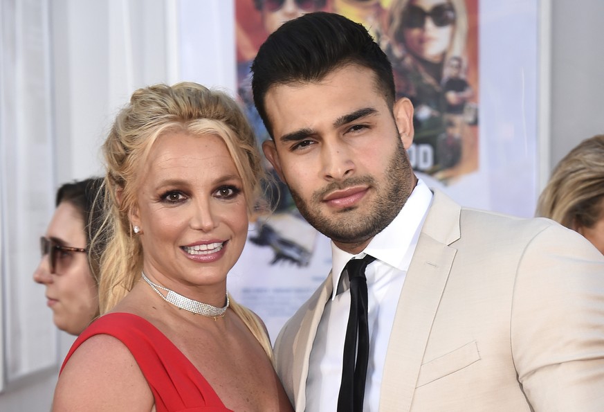 FILE - Britney Spears and Sam Asghari appear at the Los Angeles premiere of &quot;Once Upon a Time in Hollywood&quot; on July 22, 2019. Asghari has filed for divorce from Spears, a person familiar wit ...