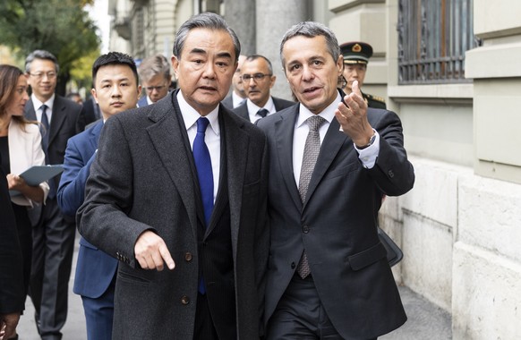 Swiss Foreign minister, Federal Councillor Ignazio Cassis, right, walks to a joint press conference with his guest Wang Yi, Foreign Minister of the PeopleÕs Republic of China, staying on an official w ...