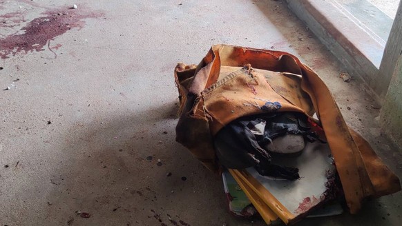 A school bag lies next to dried blood stains on the floor of a middle school in Let Yet Kone village in Tabayin township in the Sagaing region of Myanmar on Saturday, Sept. 17, 2022, the day after an  ...