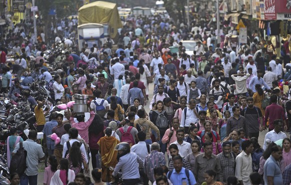 A crowd walks in a market area outside Dadar station in Mumbai, India, Friday, March 17, 2023. India will soon eclipse China to become the world&#039;s most populous country, and its economy is among  ...