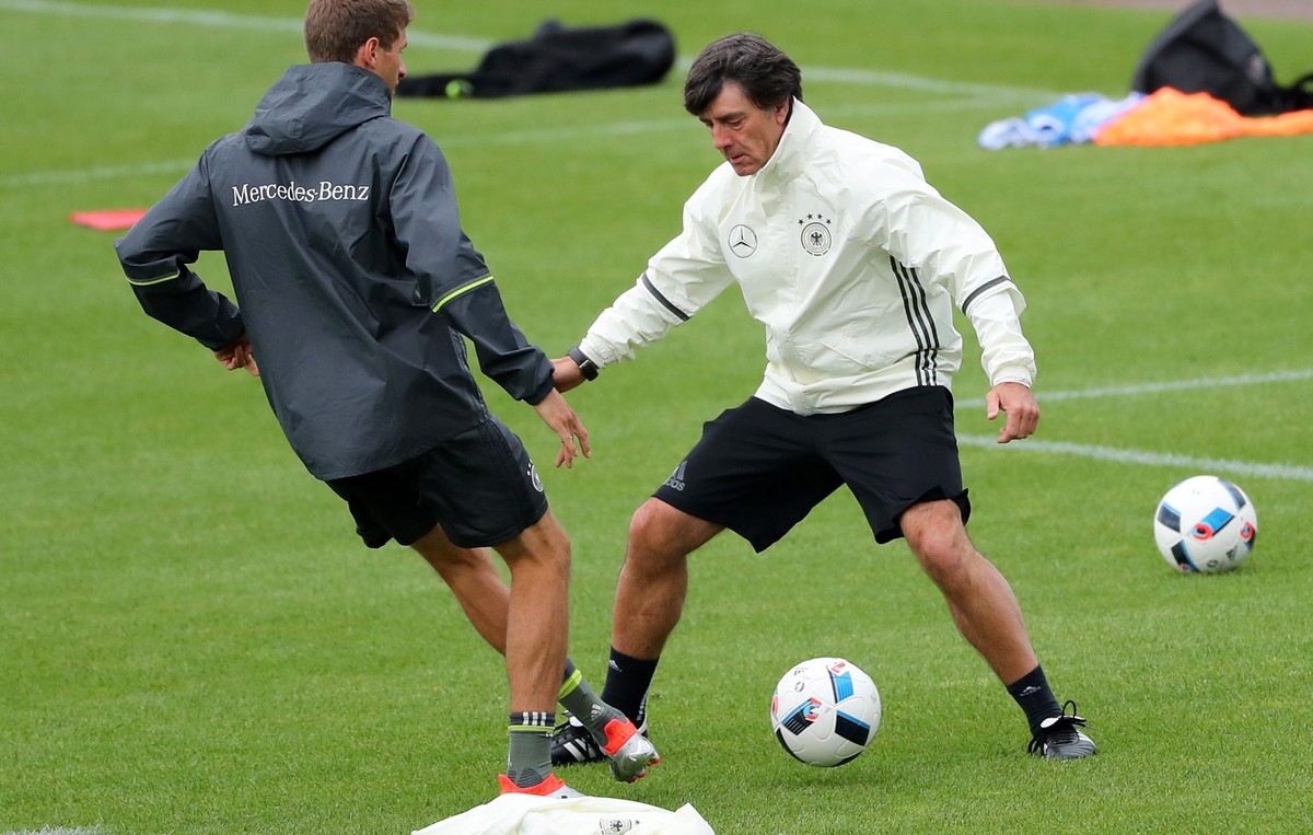 epa05364526 Germany's Thomas Mueller (L) nutmegs head coach Joachim Loew during the team's training session at their team hotel in Evian-les-Bains, France, 14 June 2016. Germany will face Po ...