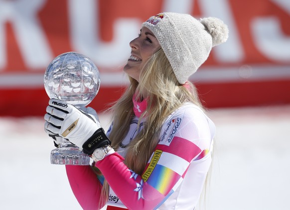 Lindsey Vonn, of the United States, holds the alpine ski, women&#039;s World Cup super-G discipline trophy, at the World Cup finals in Meribel, France, Thursday, March 19, 2015. (AP Photo/Giovanni Aul ...