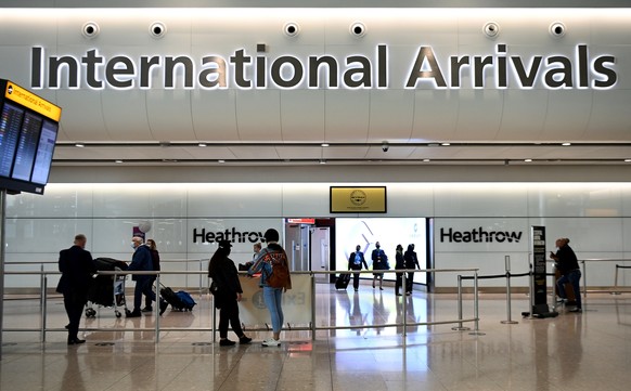 epa09175532 Travellers arrive at Heathrow Airport in London, Britain, 03 May 2021. Holidays abroad are set to resume on 17 May if the governments road map for lockdown easing continues. A cross party  ...