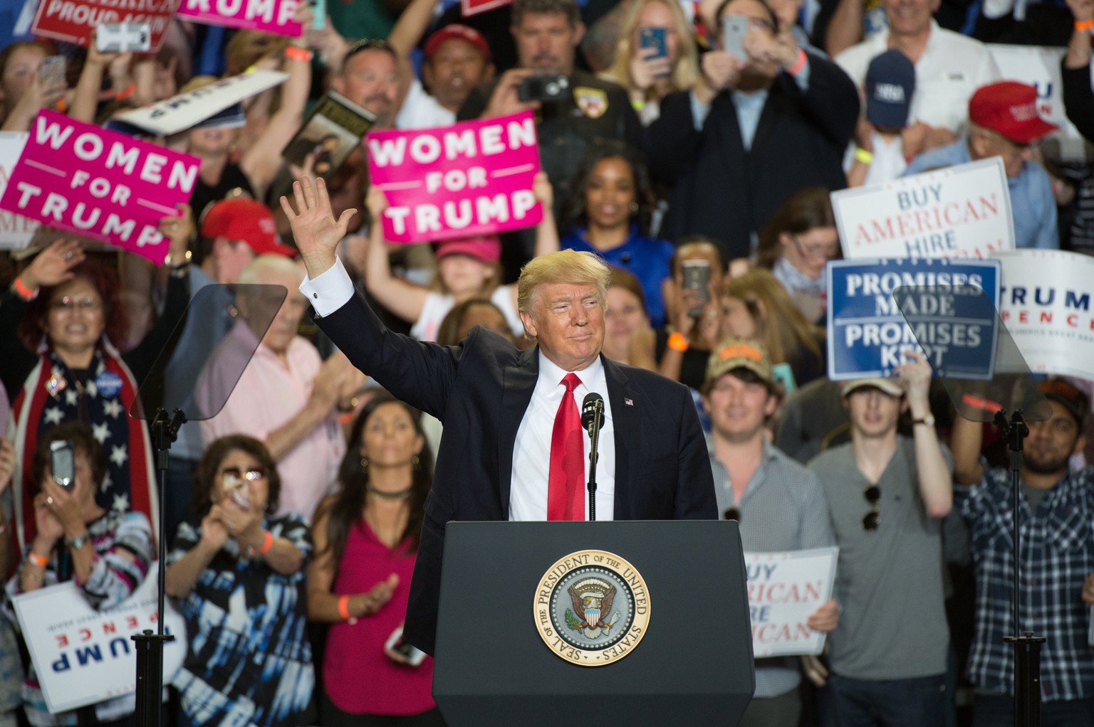 epa05936292 US President Donald J. Trump waves during a rally at the Pennsylvania Farm Show Complex in Harrisburg, Pennsylvania, USA, 29 April 2017. The rally marked the president&#039;s 100th day in  ...
