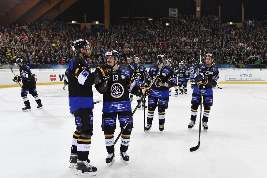 Lugano&#039;s Philippe Furrer, left, and Alessio Bertaggia, right, cheer after qualifying for the semi-finals, after the game between HC Lugano and Mountfield HK at the 90th Spengler Cup ice hockey to ...