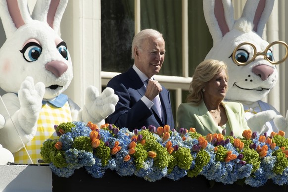 epa10567570 US President Joe Biden (2-L) stands next to First Lady Jill Biden (2-R) and Easter bunnies after delivering remarks about Easter on the Truman Balcony of the White House in Washington, ...