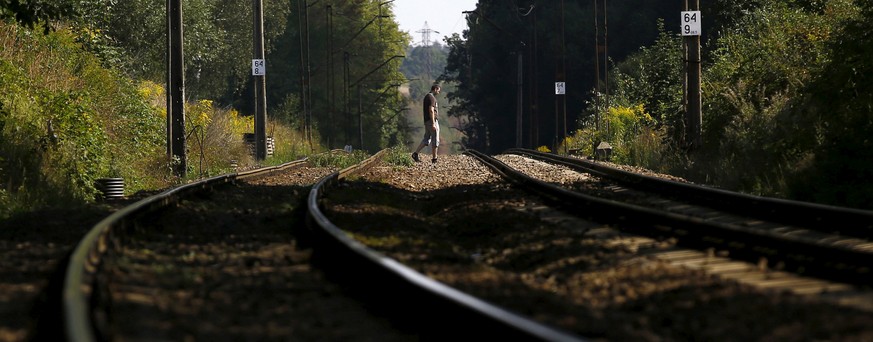 A man walks across tracks in an area where a Nazi train is believed to be, in Walbrzych, southwestern Poland August 30, 2015. REUTERS/Kacper Pempel/File Photo