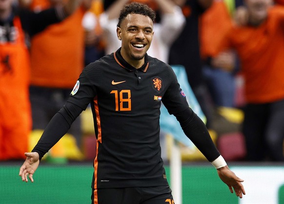 epa09291129 (lr) Donyell Malen and Memphis Depay of the Netherlands celebrate 1-0 during the UEFA EURO 2020 Group C match between North Macedonia and the Netherlands at the Johan Cruijff ArenA in Amst ...