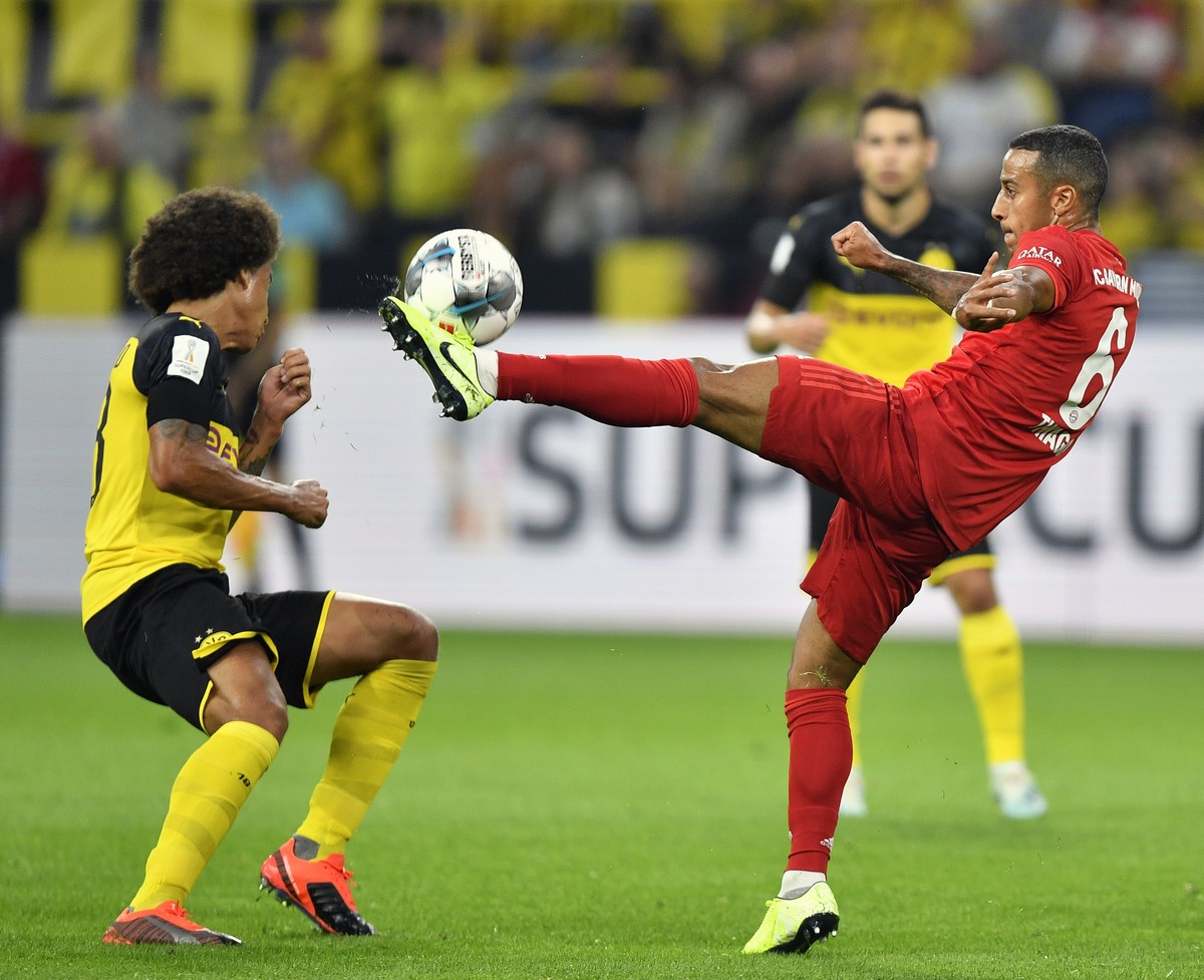 Bayern's Thiago, right, duels for the ball with Dortmund's Axel Witsel during the German Supercup final soccer match between Borussia Dortmund and Bayern Munich in Dortmund, Germany, Saturda ...