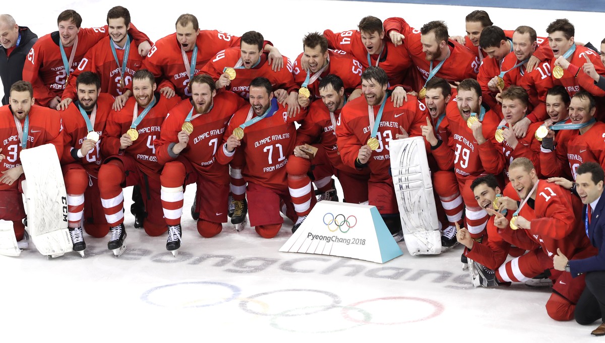 epa06563559 Gold medalists Olympic Athletes of Russia (OAR) react during the medal ceremony of the Men's Ice Hockey gold medal match between Olympic Athletes of Russia (OAR) and Germany at the Ga ...