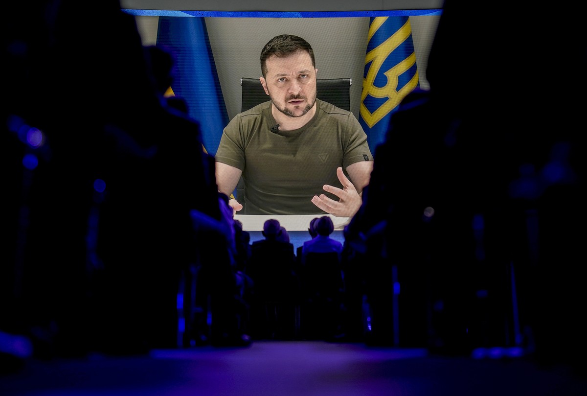 Ukrainian President Volodymyr Zelenskyy displayed on a screen as he addresses the audience from Kyiv on a screen during the World Economic Forum in Davos, Switzerland, Monday, May 23, 2022. The annual ...