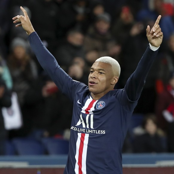 PSG's Kylian Mbappe celebrates after scoring his side's third goal during the League One soccer match between Paris Saint Germain and Amiens, at the Parc des Princes stadium in Paris, Saturd ...