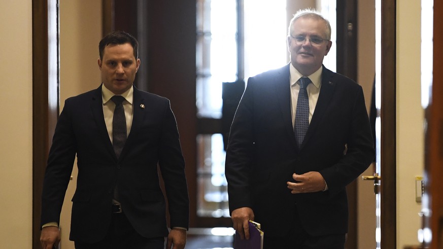 epa08584495 Australian Prime Minister Scott Morrison (R) and Australian International Development Minister Alex Hawke (R) arrive for a virtual summit with Prime Minister of Papua New Guinea James Mara ...