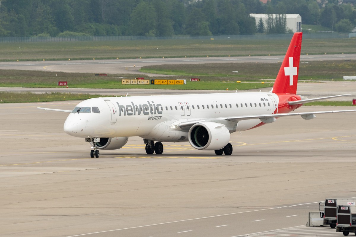 Zurich, Switzerland, May 19, 2023 HB-AZI Helvetic Airways Embraer E-195-E2 aircraft is taxiing over the apron xkwx zurich switzerland airport international flight aircraft plane travel transportation  ...