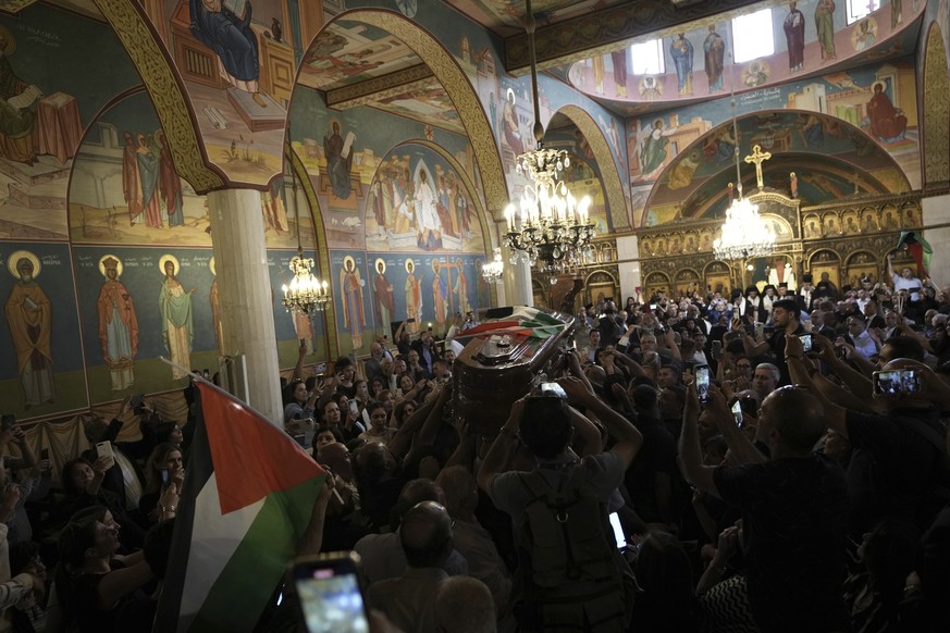 Mourners gather for the funeral of slain Al Jazeera veteran journalist Shireen Abu Akleh at a church in the Old City of Jerusalem, Friday, May 13, 2022. Abu Akleh, a Palestinian-American reporter who  ...