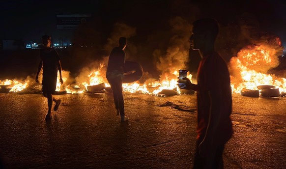 epa10824641 Libyan demonstrators burn tires to protest against the meeting of the Foreign Minister of the National Unity Government, Najla al-Mangoush, with her Israeli counterpart in Italy , in Tripo ...